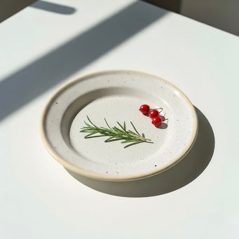 Minimal food elements on the cream speckled dinner plate