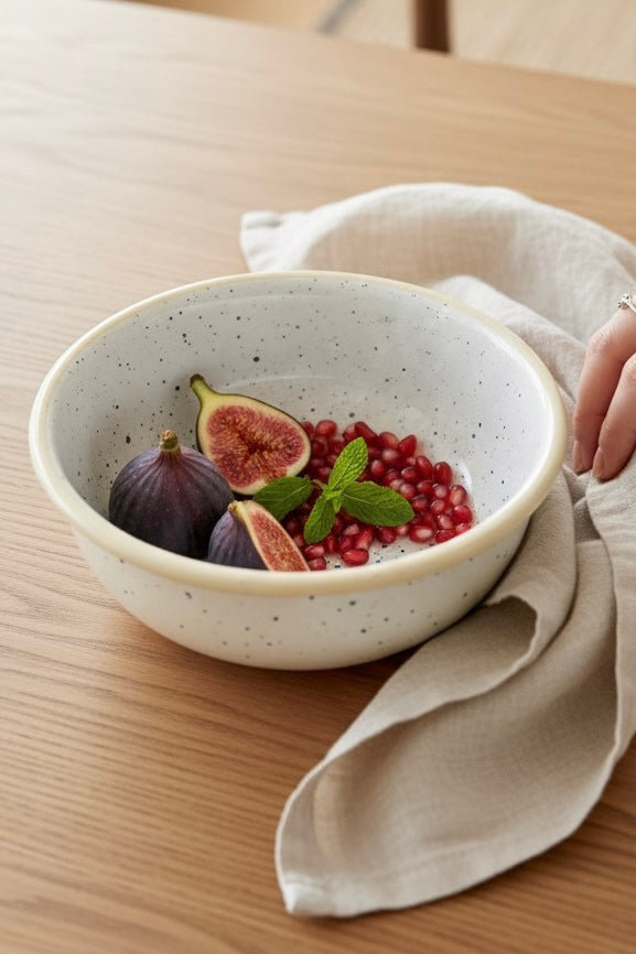 Minimal food in cream speckled cereal enamel bowl placed on wooden table for breakfast 
