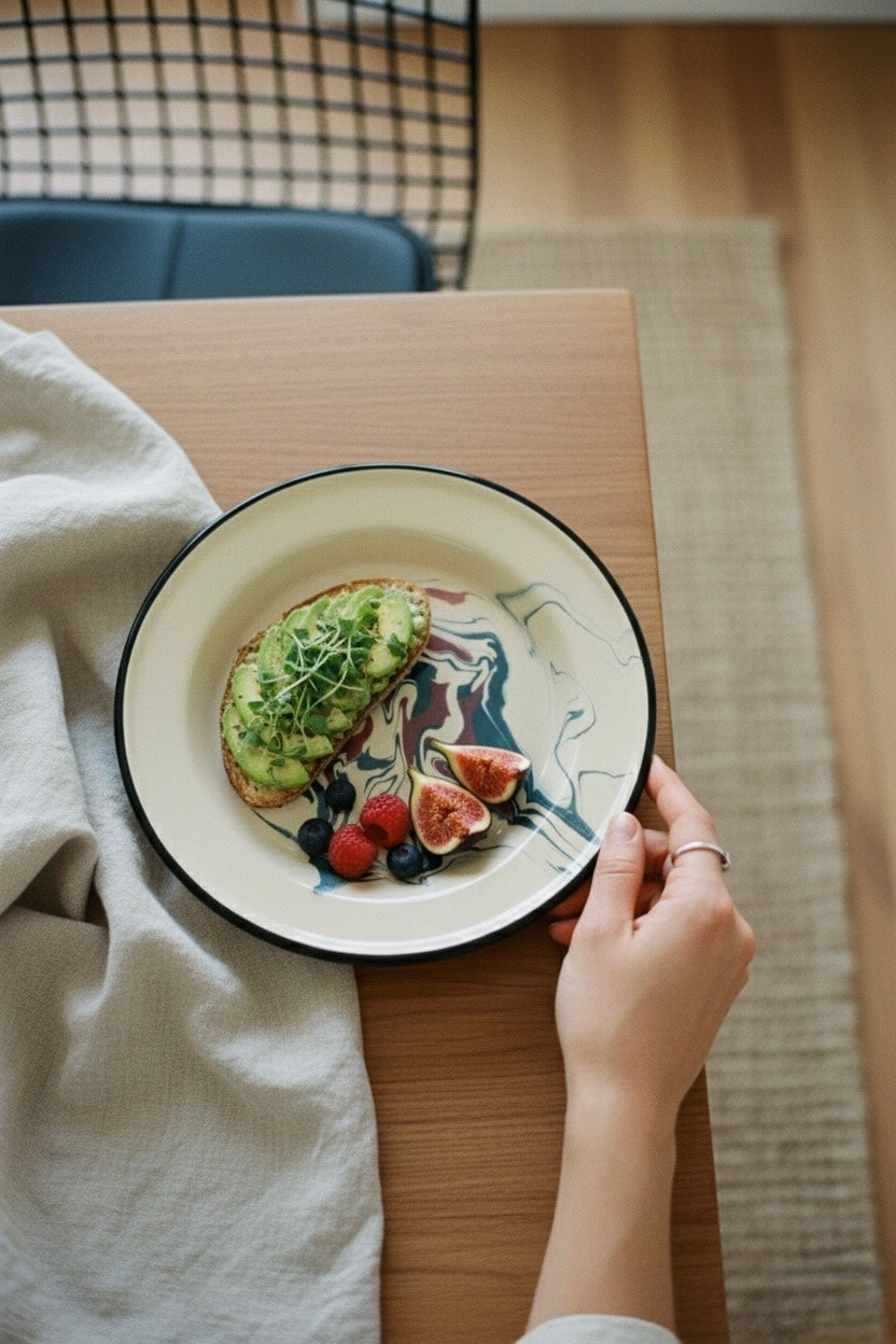 Top view of enamelware plate with minimal food styling