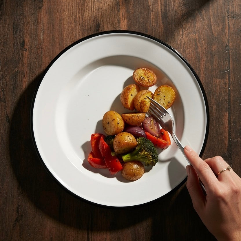 Alpine enamel dinner plate with potato on it