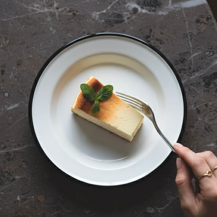 Alpine enamel side plate with dessert on it