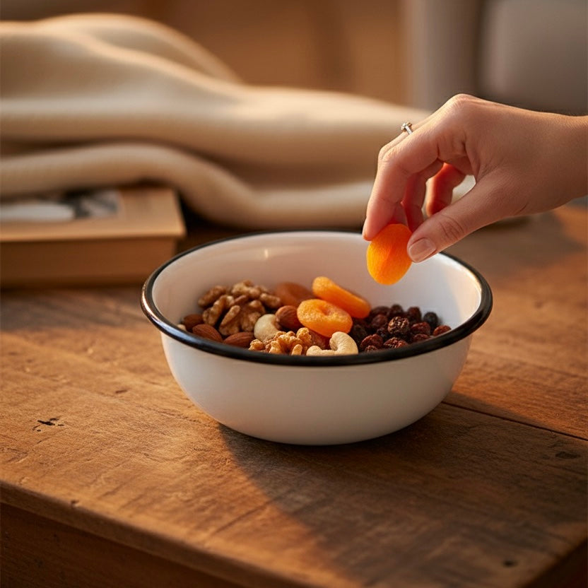 Serving fruits in alpine cereal enamel bowl in evening 